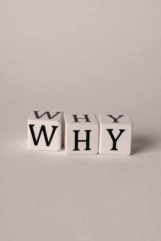 pexels-photo-15368263-15368263 Three cubes spelling 'WHY' on a plain background, symbolizing curiosity and questioning.